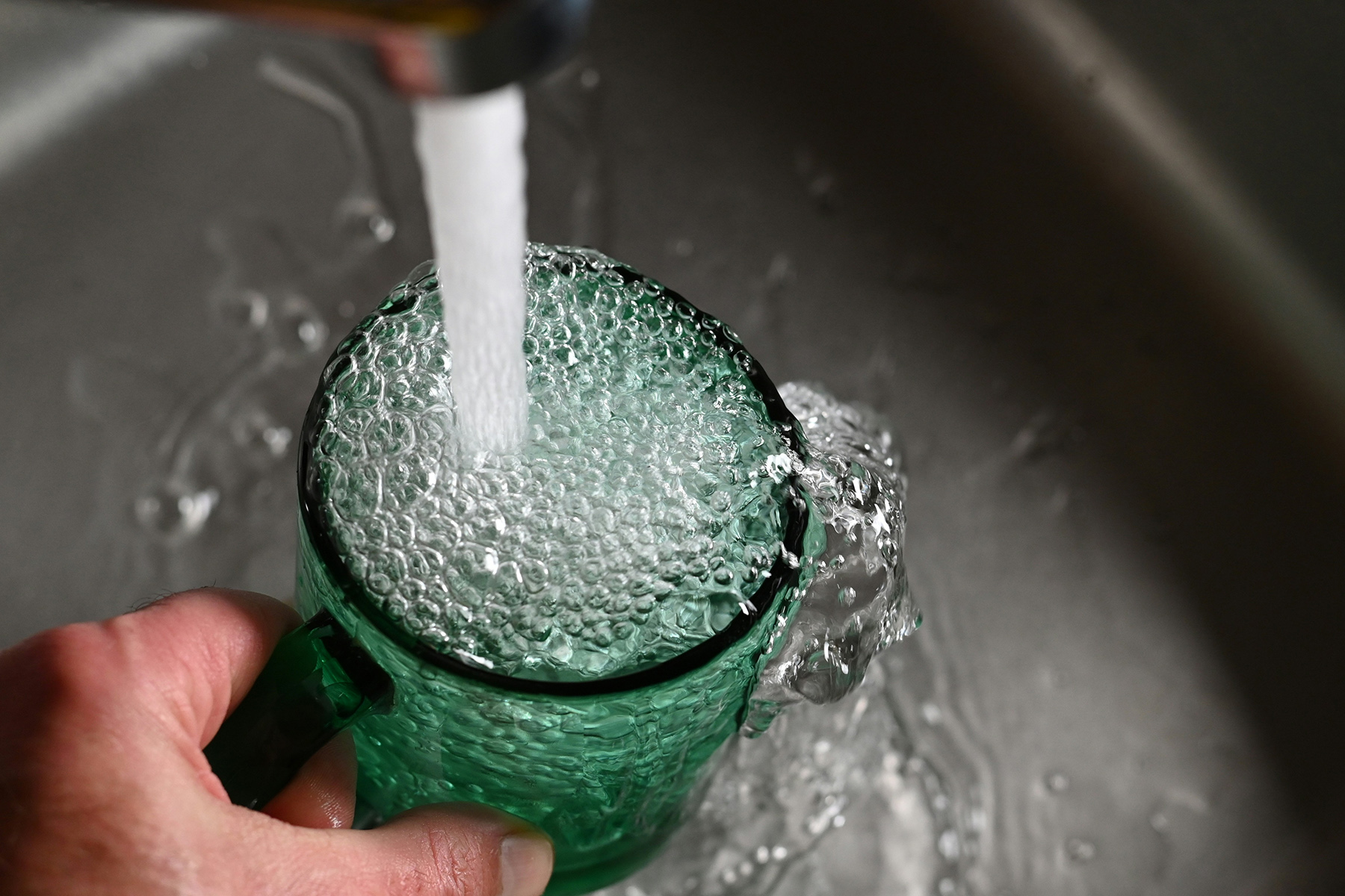 Tap water filling up cup